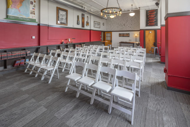 Two long rows of chairs (four wide on either side of an aisle) in The Sunset Room.