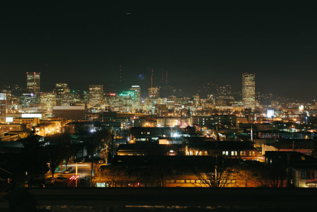 The Portland city skyline at night, viewed from the roof deck at Revolution Hall.