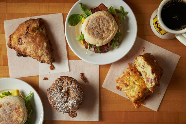 A full spread of Martha's baked goods: pastries, egg sandwich, coffee and more