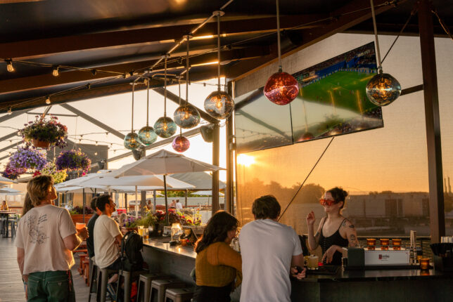 Bar and impending sunset on the Roof Deck at Revolution Hall, with soccer on TVs.